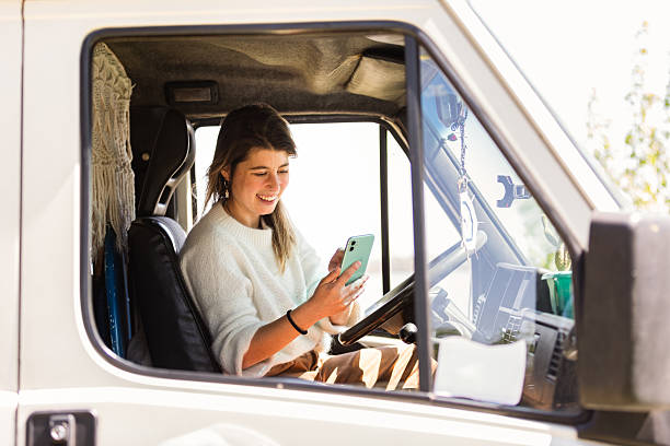 istock Young woman taking a call on a motorhome 2230888089