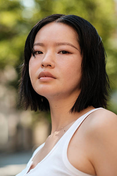 istock Young asian woman posing with serious expression outdoors 2230888218