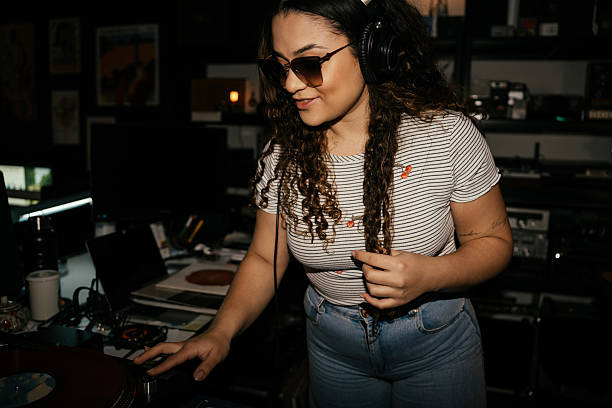 istock Young woman having fun in record store 2230888497