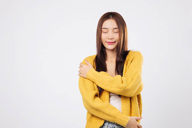 istock Hug for confidence, a smiling woman gently holds herself 2230889564