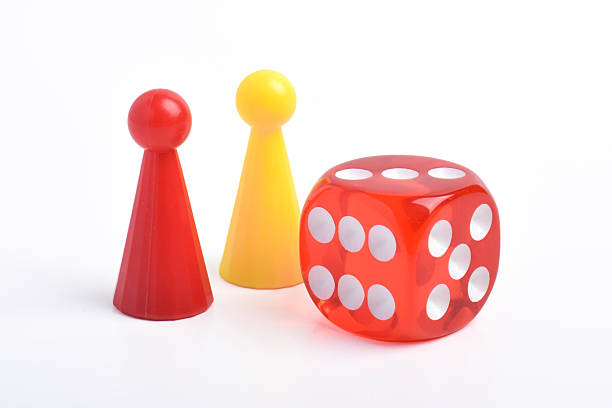 istock Red and yellow board game figures and dice 2230891515