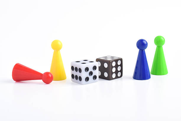 istock Colorful board game figures and dice 2230891635