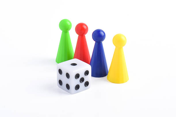 istock Colorful board game figures and dice 2230891636