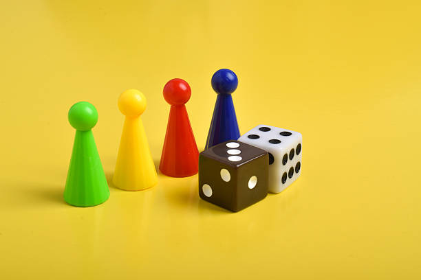 Close-Up Arrangement Of Board Game Pieces Climbing Up Ladder