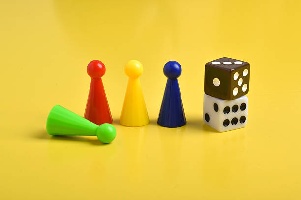 istock Colorful game chips and two dice on yellow background 2230892078