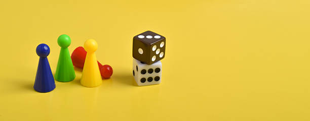 istock Colorful game chips and two dice on yellow background 2230892093