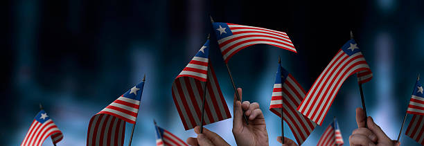 istock Liberia flags in their hands on a blurred urban background 2230895622