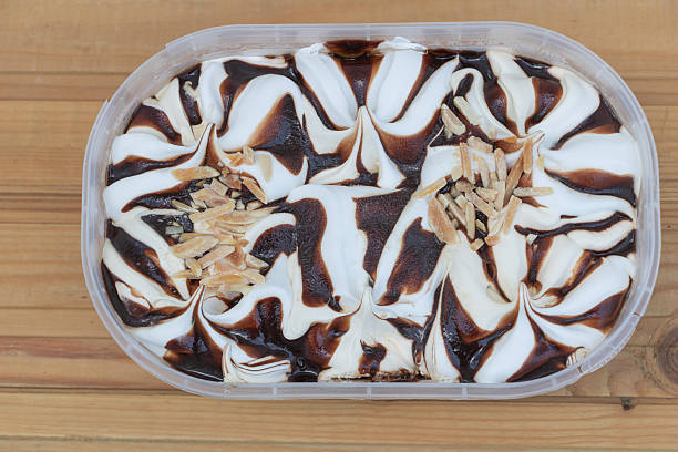 istock Swirled Vanilla and Chocolate Ice Cream with Almond Slivers on Rustic Wooden Surface 2230900811