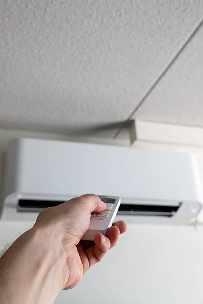 istock Controlling Home Climate With A Modern Air Conditioner Remote 2230905581