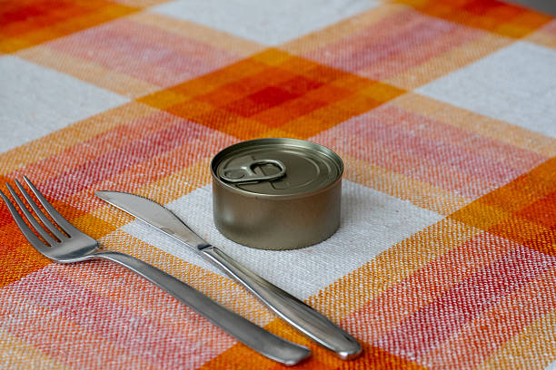 Single Serving Tin Can On A Tablecloth With Cutlery