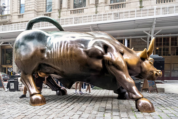 New York City, USA - June 15, 2025: Wall Street Charging Bull Sculpture at Lower Manhattan