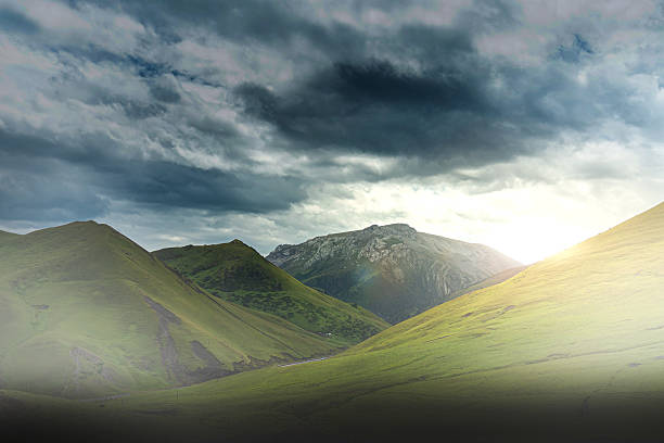 This is a landscape painting of a grassland. In the picture, the vast green grassland spreads out like a green carpet, with distant mountains and bright green grass. Several trees are scattered here and there, adding a touch of natural charm. Above is an open sky, with bright colors. The overall atmosphere is fresh and natural, conveying a peaceful and distant rural atmosphere. It seems that one can smell the fragrance of the grass and feel the comfort of the gentle breeze. However, from the presentation of the picture, the characteristics of the grassland can be associated with its vastness and grandeur.