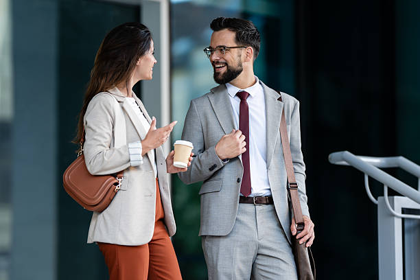 istock Business partners enjoying a coffee break and having a conversation outside the office building 2230907955