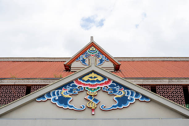 Architectural detail showcasing traditional temple roof design with intricate mosaic artwork. The vibrant colors and patterns reflect cultural heritage, suitable for cultural studies or architectural inspiration.
