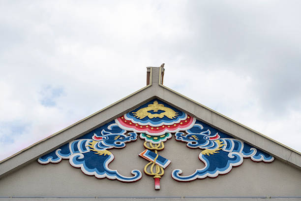 Architectural detail showcasing traditional temple roof design with intricate mosaic artwork. The vibrant colors and patterns reflect cultural heritage, suitable for cultural studies or architectural inspiration.