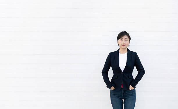 istock Confident woman standing with hands in pockets 2230910929
