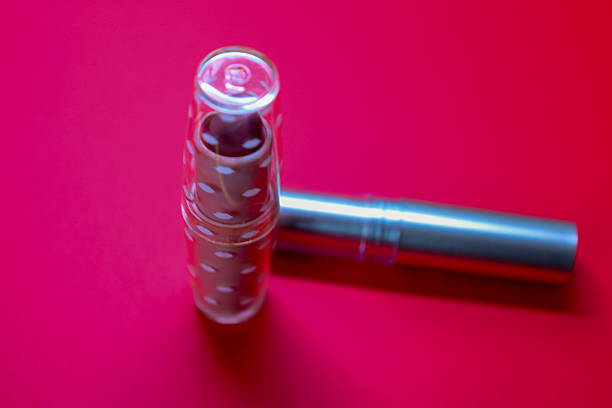 Using cosmetics helps to accentuate beauty, while a vibrant background attracts attention and creates a striking shot. The macro photo of the nail polish captures its texture, which may be interesting for beauty enthusiasts.