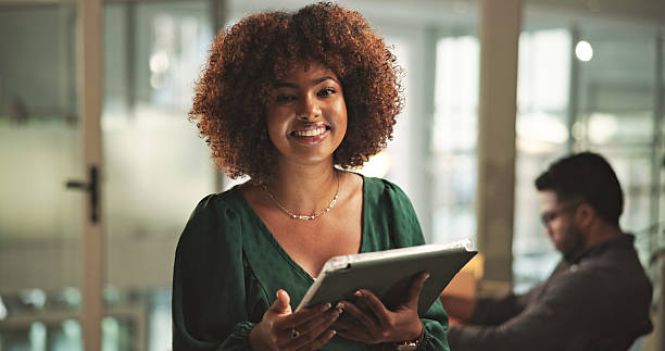 istock Confident Professional Smiling Woman Holding Document in Office Setting 2230913224