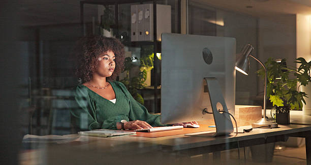 istock Focused Professional Working Late at Night in Modern Office Environment 2230913240