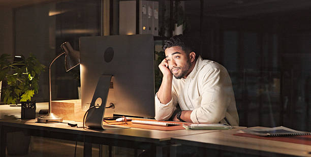 istock Man Working Late at Night in a Modern Office Environment 2230913253