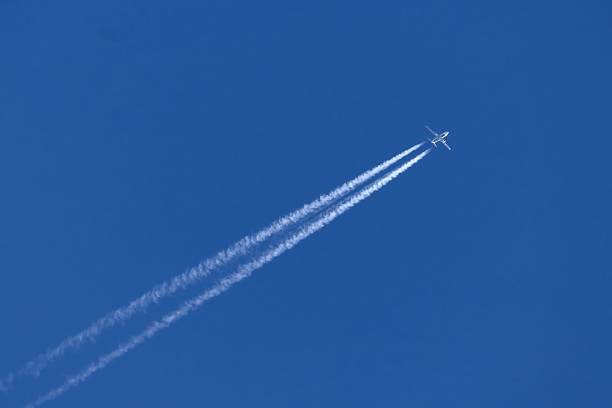 istock High-Altitude Airplane Leaving Contrails Across Clear Blue Sky 2230913558