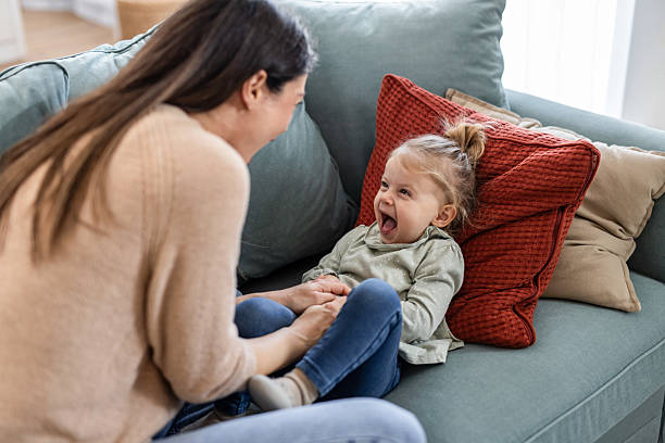 istock Mother and daughter sharing a playful moment on the sofa 2230913751