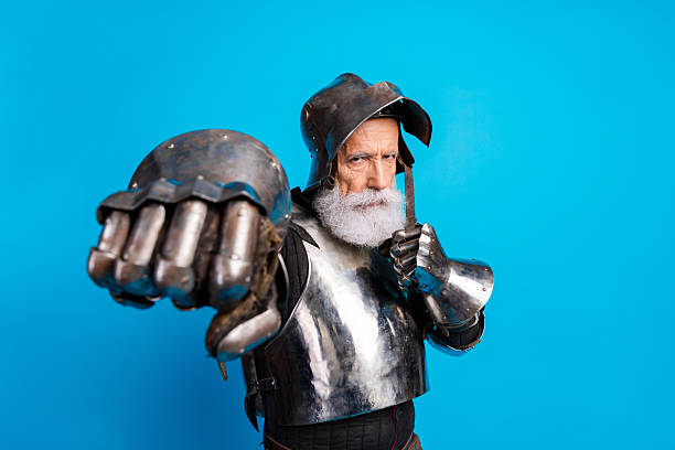 istock Senior man dressed in medieval armor posing confidently against a blue background 2230915263