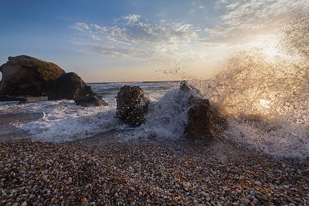 Waves beat on stones on the seashore. Seascape