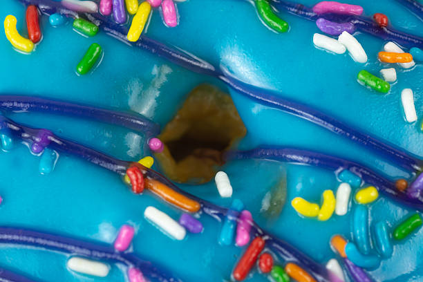 Detailed indoor studio stock image of assorted donuts, beautifully arranged to showcase a variety of flavor blueberry. The vibrant colors and textures highlight the delicious toppings, making this image perfect for food advertisements, bakery promotions, dessert menus, or lifestyle concepts related to sweet indulgence and snack enjoyment.