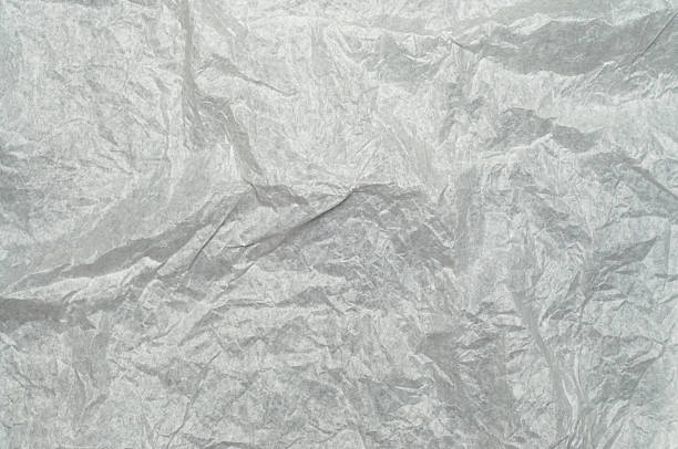 istock Wrinkled white package paper texture, isolated on background. Rough creased surface ideal for packaging, wrapping, crafts, scrapbooking, design, and artistic projects. 2230919021