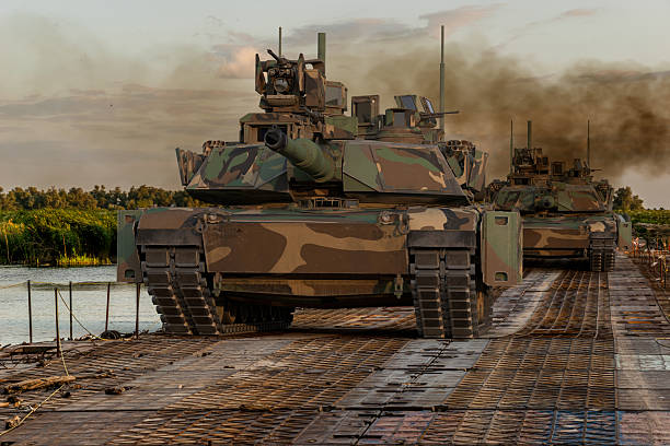 M1A2 Sep Abrams Tusk II tank at a training ground while crossing a water obstacle via a floating bridge