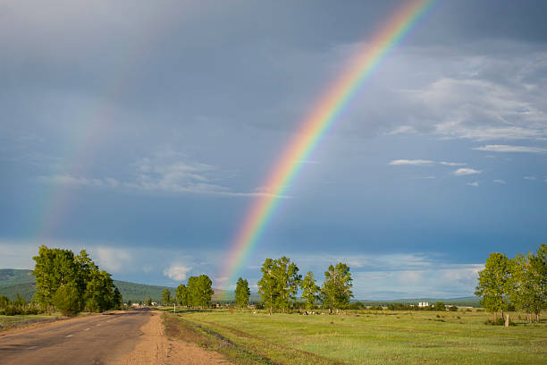 istock Rainbow over the small village in Siberia 2230921923