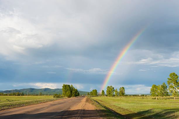 Rainbow over the small village in Siberia
