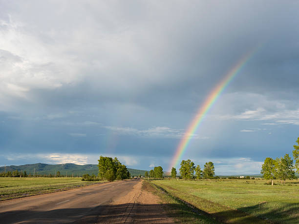 istock Rainbow over the small village in Siberia 2230921940