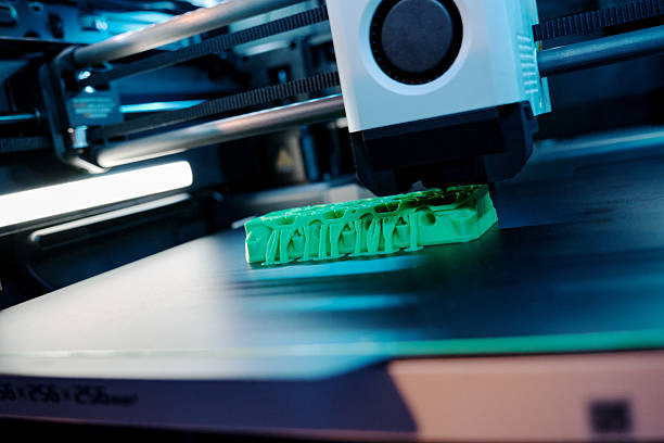 istock 3D Printer Creating a Detailed Object in a Modern Workspace With Blue Lighting and a Sleek Design 2230922713