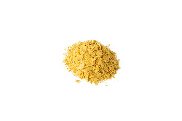 istock Savoury vegan yeast flakes heap isolated on white background. 2230925022