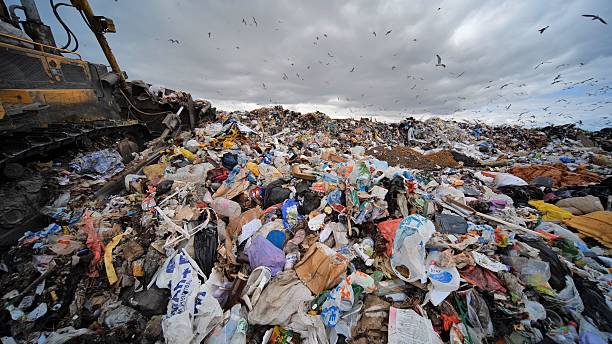 istock Work of a bulldozer at a landfill. 2230925761