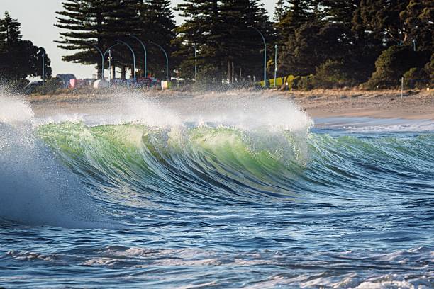 istock Vibrant ocean wave near a sandy beach. 2230930052