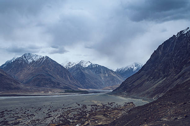 istock Expansive Ladakh valley with winding rivers, sparse vegetation, and Himalayan mountain peaks under dramatic sky 2230931791