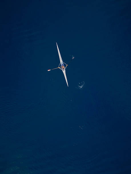 istock Single Rowing Boat on Deep Blue Sea 2230933324