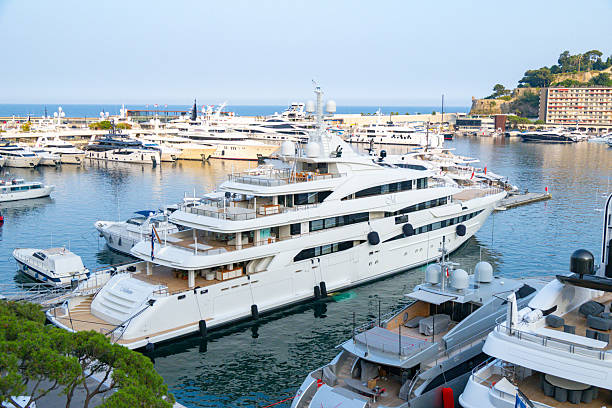 Mimtee is a motor yacht in the Monaco harbour in in La Condamine and Monte Carlo from above during a beautiful summer day. Various yachts and superyachts are moored in the port of the city on the French Côte d'Azur.