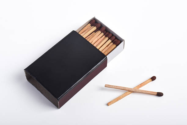 Low angle close-up view of burnt matches on a receding background.
