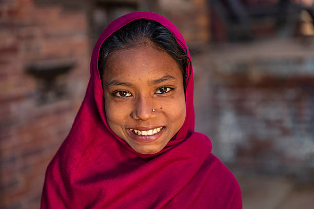 Portrait of happy young Nepali girl in Bhaktapur, Nepal Portrait of young Nepali girl, she lives in Bhaktapur. Bhaktapur is an ancient town in the Kathmandu Valley and is listed as a World Heritage Site by UNESCO for its rich culture, temples, and wood, metal and stone artwork. indian wedding stock pictures, royalty-free photos & images