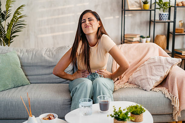 istock Young Woman Having A Stomachache At Home 2230945707