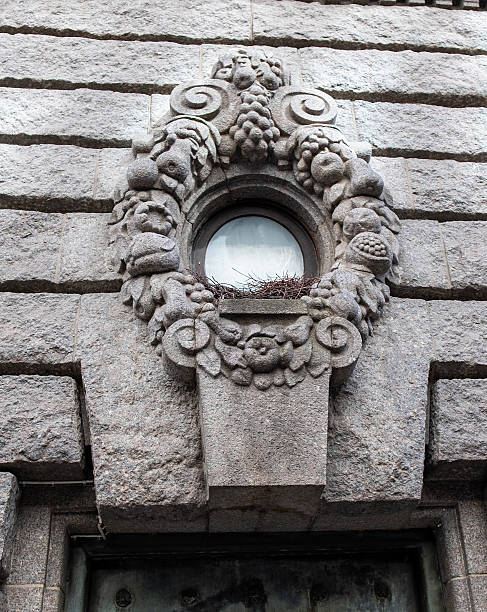 istock An architectural element, stucco, with a light window, on the facade of an old building in Stockholm. 2230946722