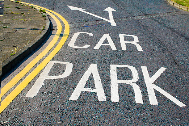 Directions on the road inro a parking lot.