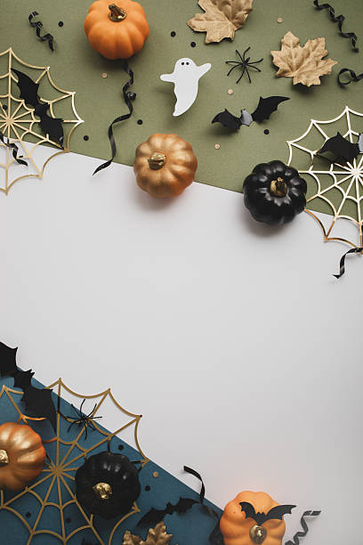 istock Happy Halloween party border template from pumpkins, bats, spider web, ghosts on vertical background top view. 2230950982