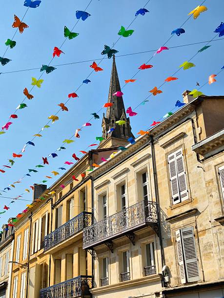 istock Cathedral tower of Bergerac with old stone facades and multi-colored decoration in front 2230951408