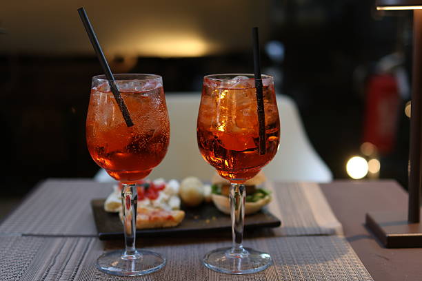 istock Spritz cocktails with appetizers on restaurant table at sunset 2230951484