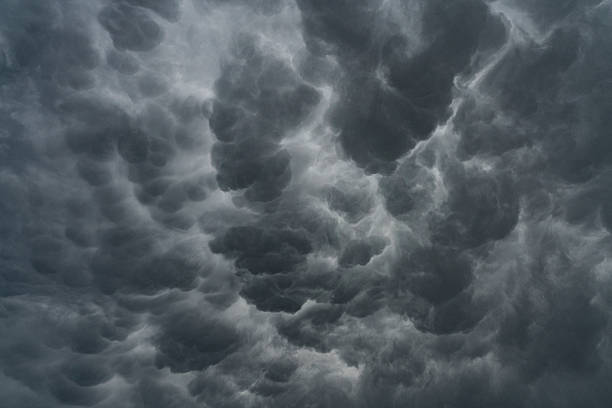 Stormy sky with dark gray dramatic clouds before thunderstorm, rain and wind, extreme weather.